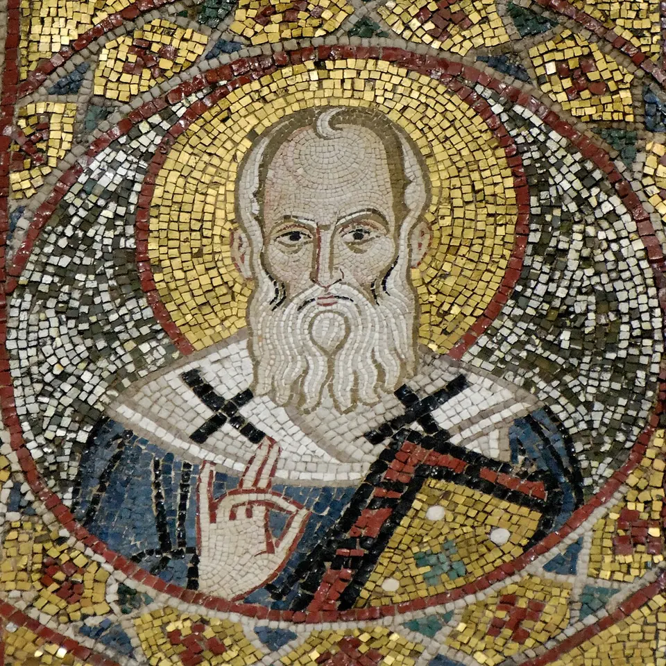 Mosaic roundel of a balding saint with a long white beard and a white stole marked with black crosses, raising his hand, on a gold ground