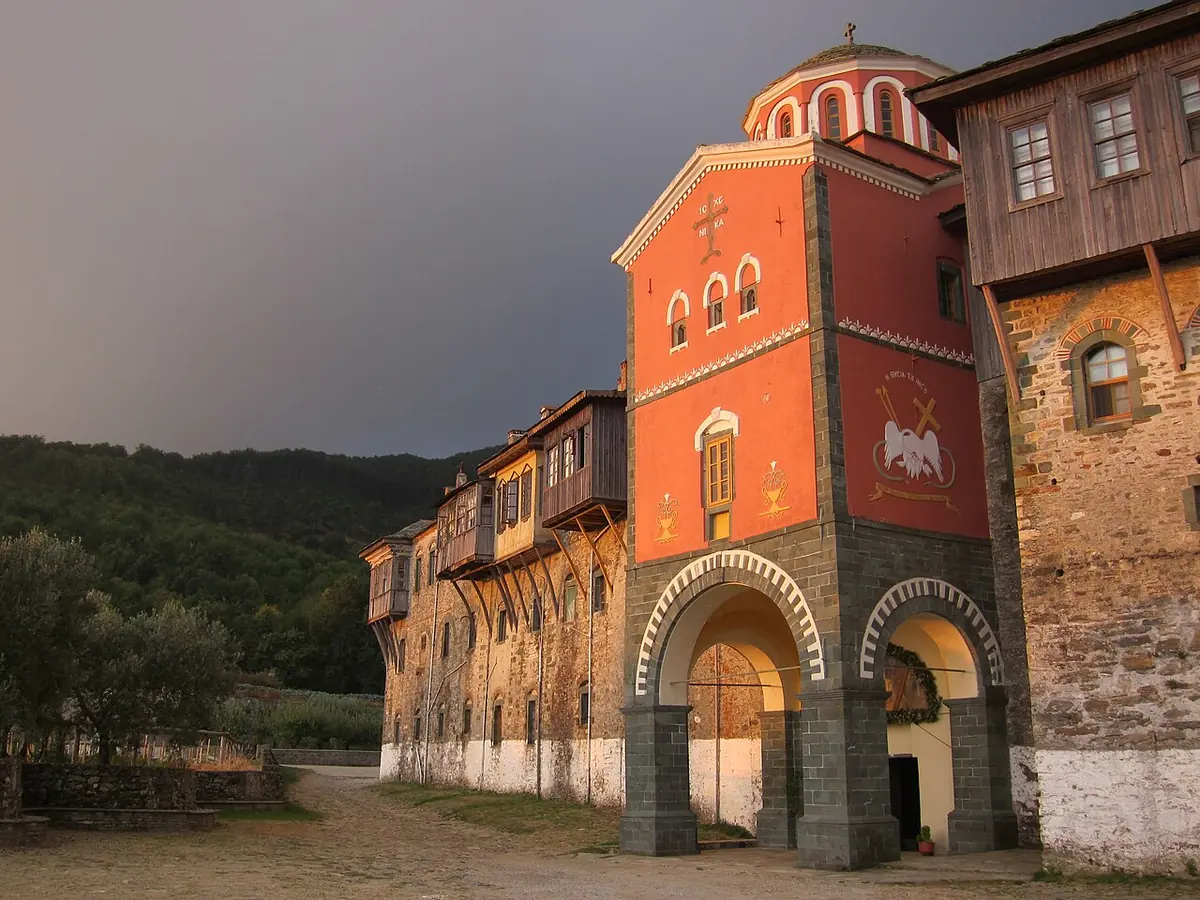 The red-painted church tower and wooden balconies of Philotheou Monastery on Mount Athos at dawn
