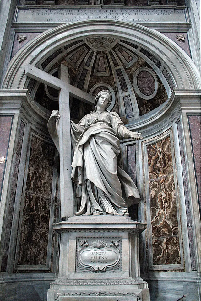 Colossal white marble statue of St. Helena in a niche of St. Peter's, one arm around a huge cross and the other stretched out, above an inscribed base