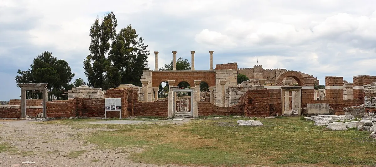 Wide view of the ruined Basilica of St. John at Ephesus, with columns and brick walls on a hillside