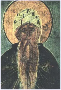 Close view of an old Russian painted image of a hermit with a large golden halo, a light patterned hood and a very long, narrow gray beard, against a dark green background