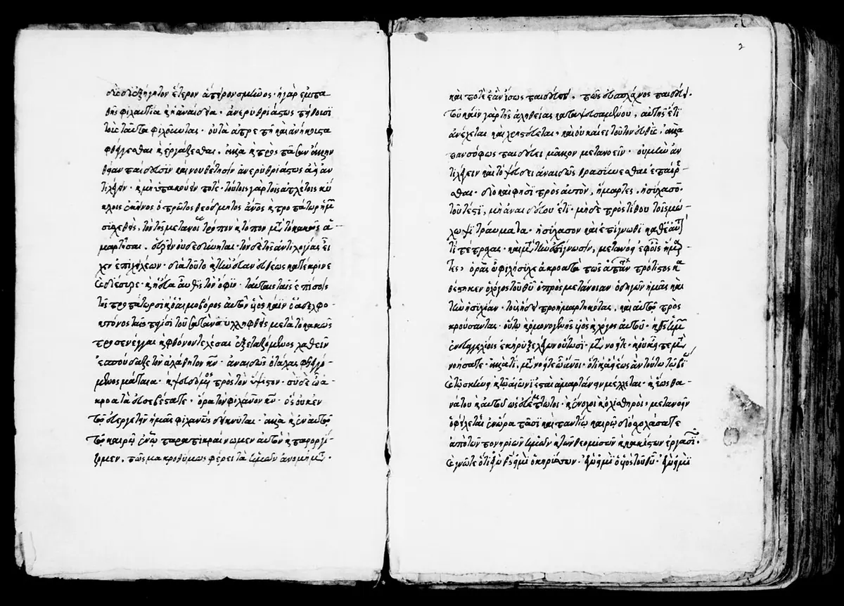 An open medieval manuscript photographed in black and white, two pages of neat, small Greek handwriting in single columns
