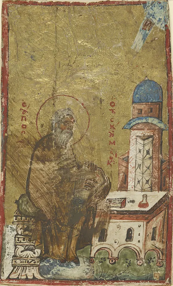 A small Byzantine manuscript painting on gold of a seated elderly monk writing at a lectern, beside a tall church building with a blue dome