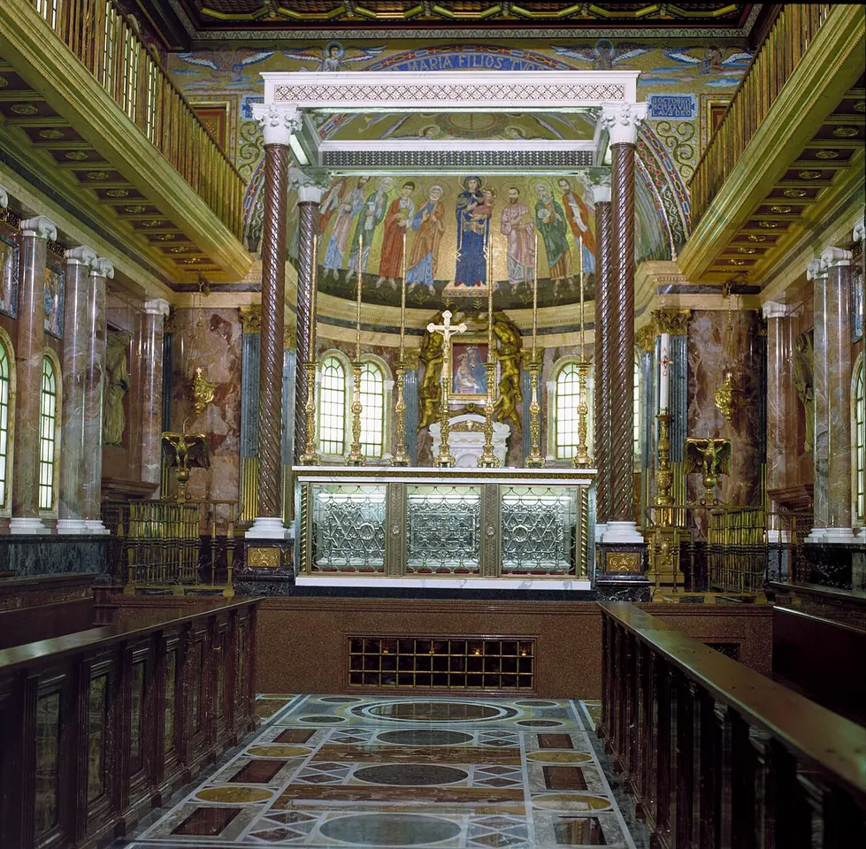 Marble-floored church interior with carved wooden choir stalls leading to a high altar under a gilded canopy and an apse mosaic of saints
