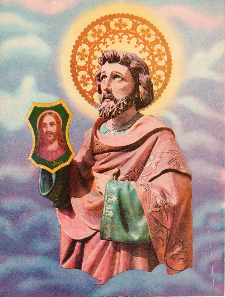 Devotional print of a statue of St. Jude in a rose-colored robe with a golden halo, holding a green-framed medallion with the face of Christ, against a sky of clouds