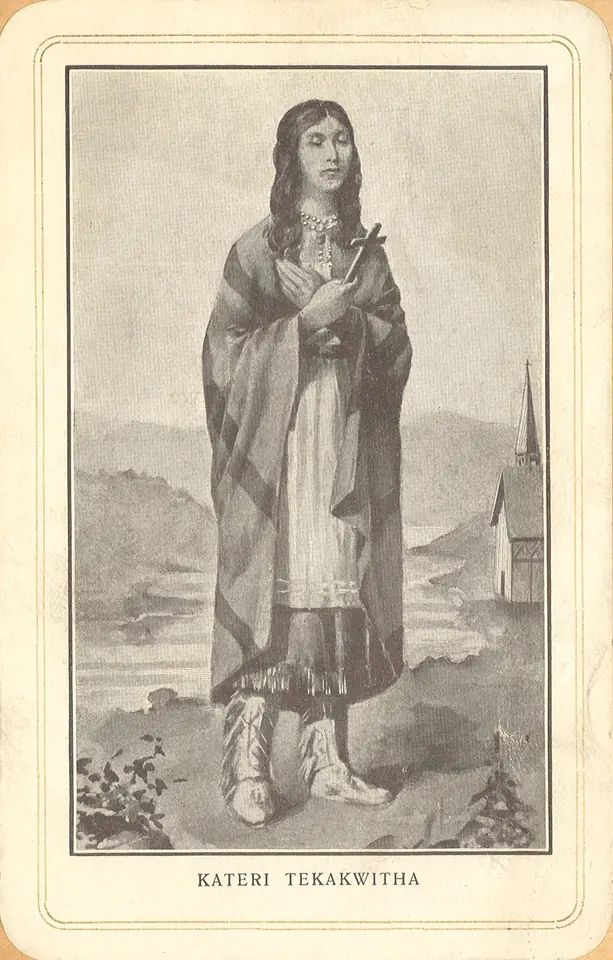 Old devotional print of Kateri standing in a fringed robe and moccasins, holding a cross, with a riverside church behind her and her name printed below
