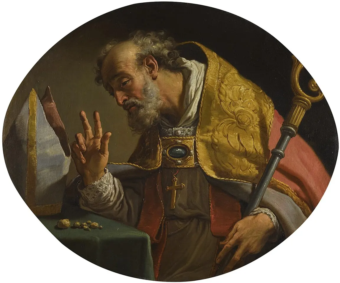 Oval oil painting of an elderly bearded bishop in a gold cope and red mantle, raising his hand in blessing, his crozier beside him and small stones on the table in front of him