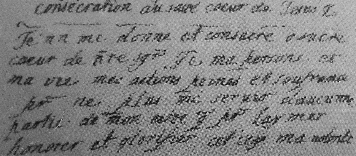 Black-and-white photograph of four lines of seventeenth-century French handwriting beginning "consécration au sacré coeur de Jésus"