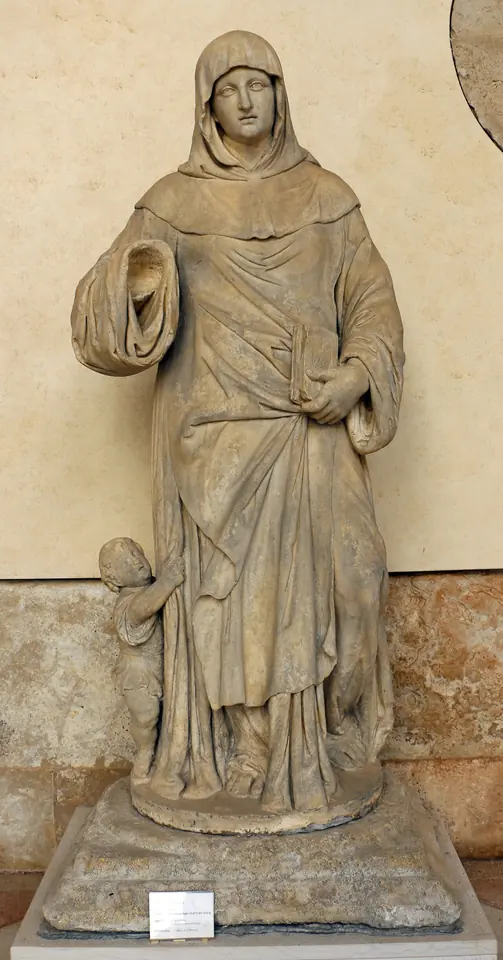 Marble statue of St. Marina in a hooded monastic habit with a small child at her feet