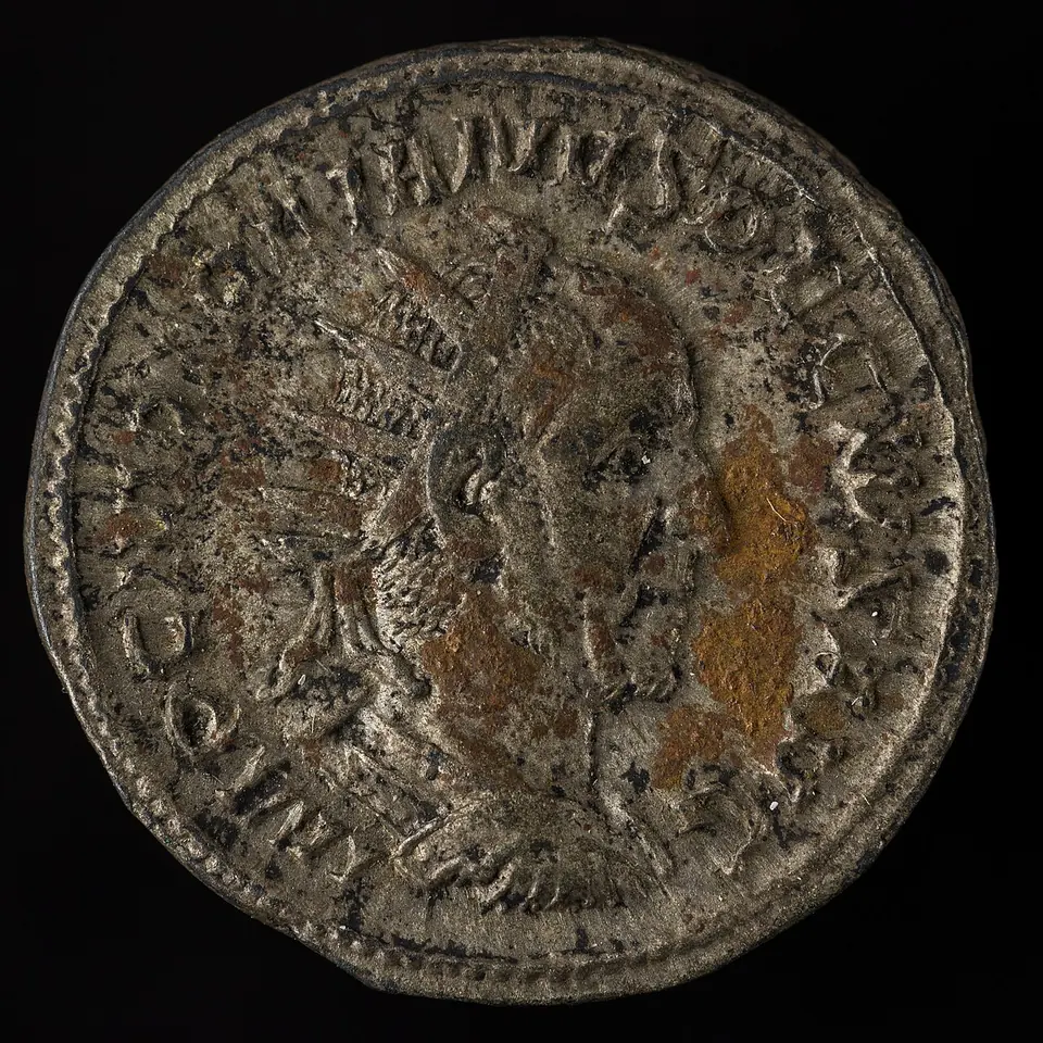 A worn silver Roman coin showing the bust of Emperor Decius wearing a radiate crown, with a Latin inscription around the rim