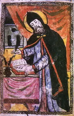 Brightly colored Armenian manuscript painting of a haloed monk in a black hooded cloak writing with a pen in a large book on a draped desk