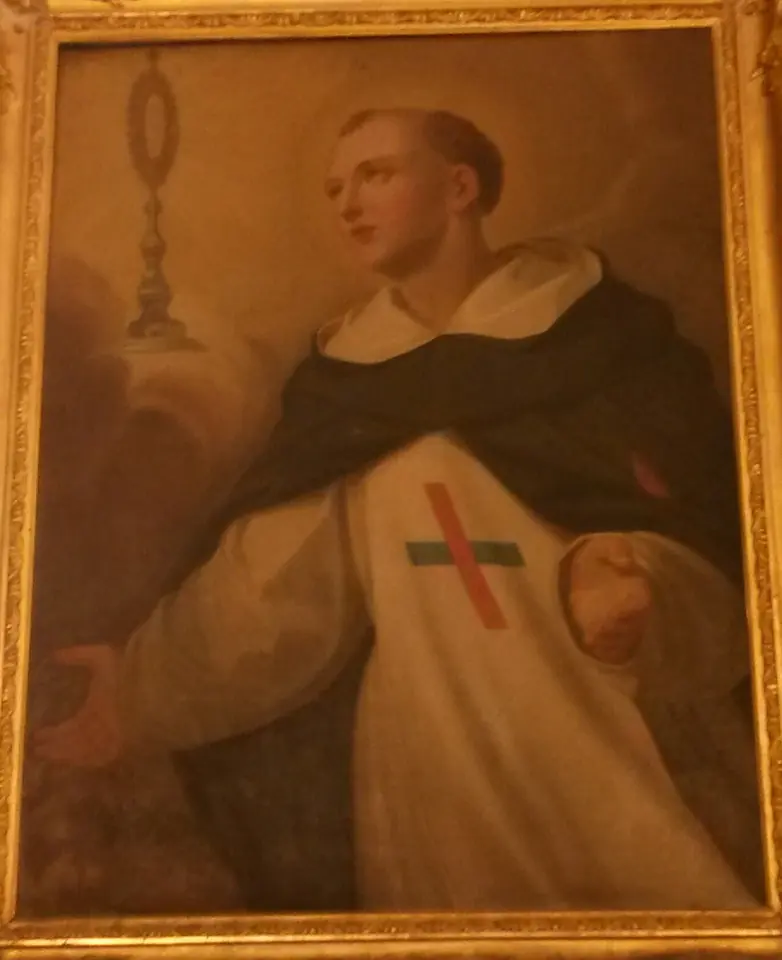 Eighteenth-century painting of a young friar in a white habit with a red and blue cross and a dark cape, gazing toward a radiant monstrance