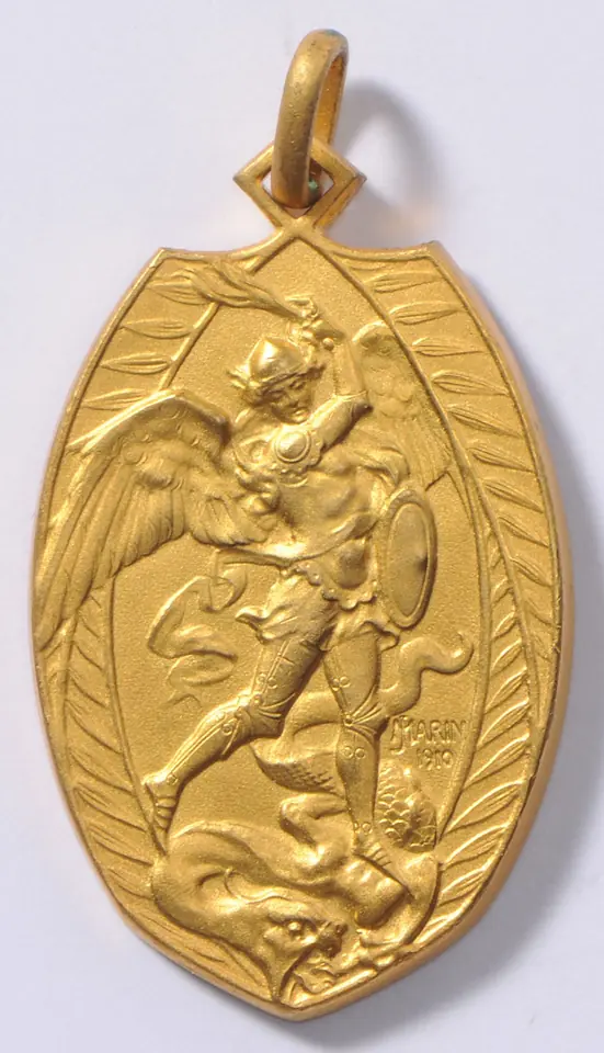 Gilded shield-shaped medal with a loop, showing St. Michael with wings and shield driving his sword down at a dragon beneath him