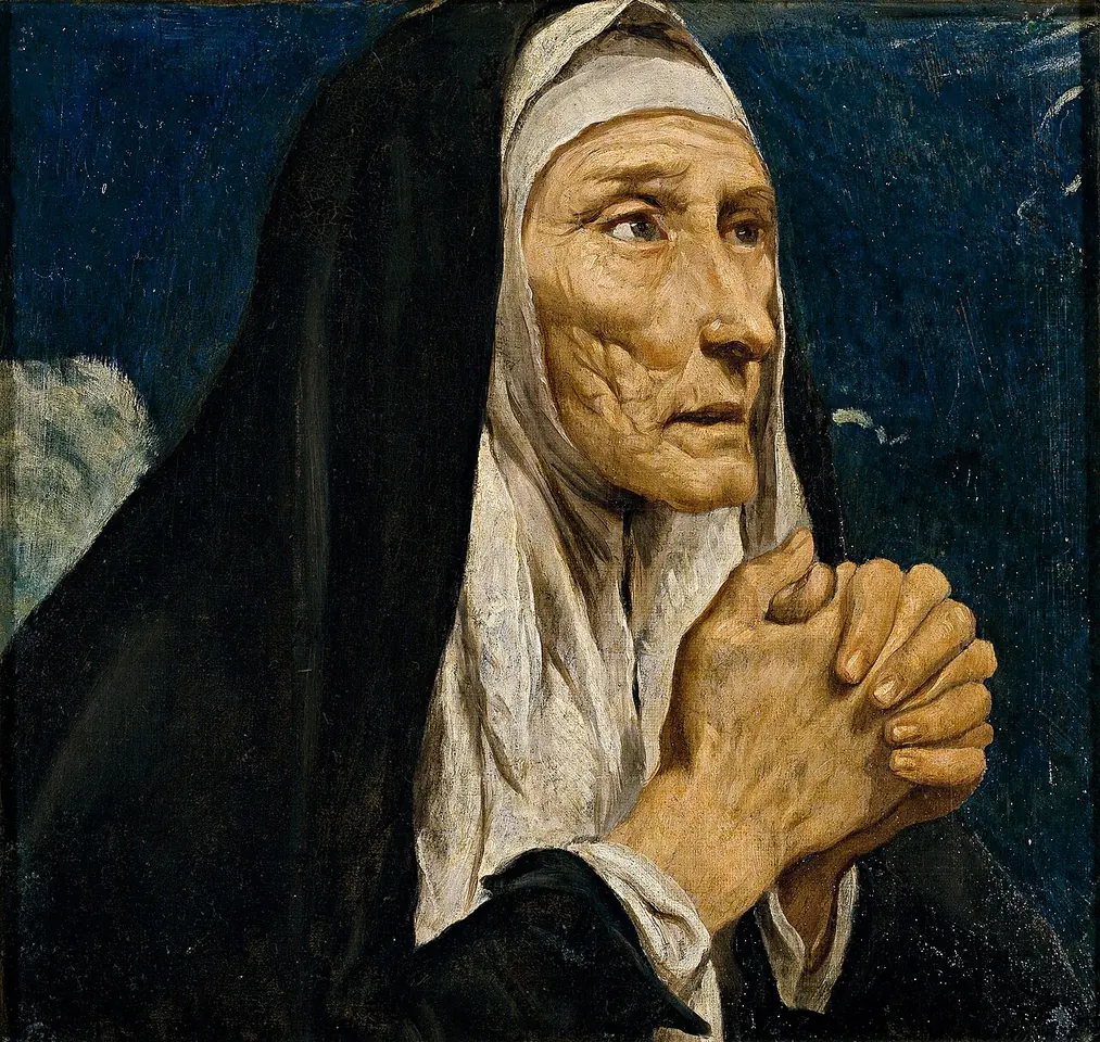Pintura en primer plano de una mujer anciana de rostro muy arrugado, con toca blanca y velo negro, que junta sus manos huesudas en oración y mira hacia arriba