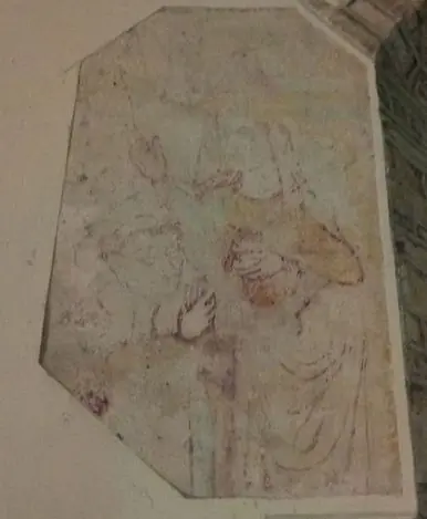 A faded medieval wall painting on a whitewashed wall, showing a veiled figure with one hand raised and the other held to her breast, in soft red and ochre lines