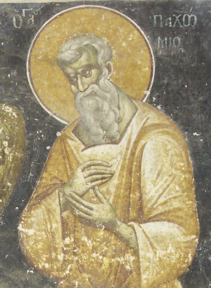 Byzantine fresco of an elderly gray-bearded saint with a golden halo, his hand on his breast, inscribed with his name in Greek