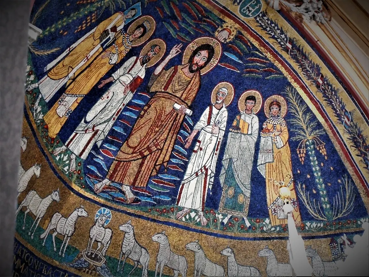 Mosaic of Christ in a golden robe raising his hand, with saints on either side and, at the far left, Pope Paschal with a square halo holding a model of the church