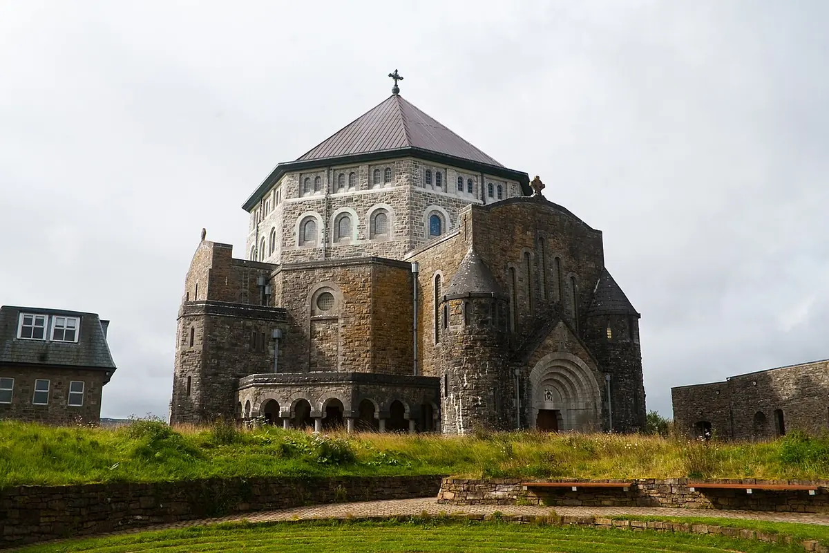 The octagonal stone basilica on Station Island in Lough Derg, with a domed roof and a cross, seen across a lawn