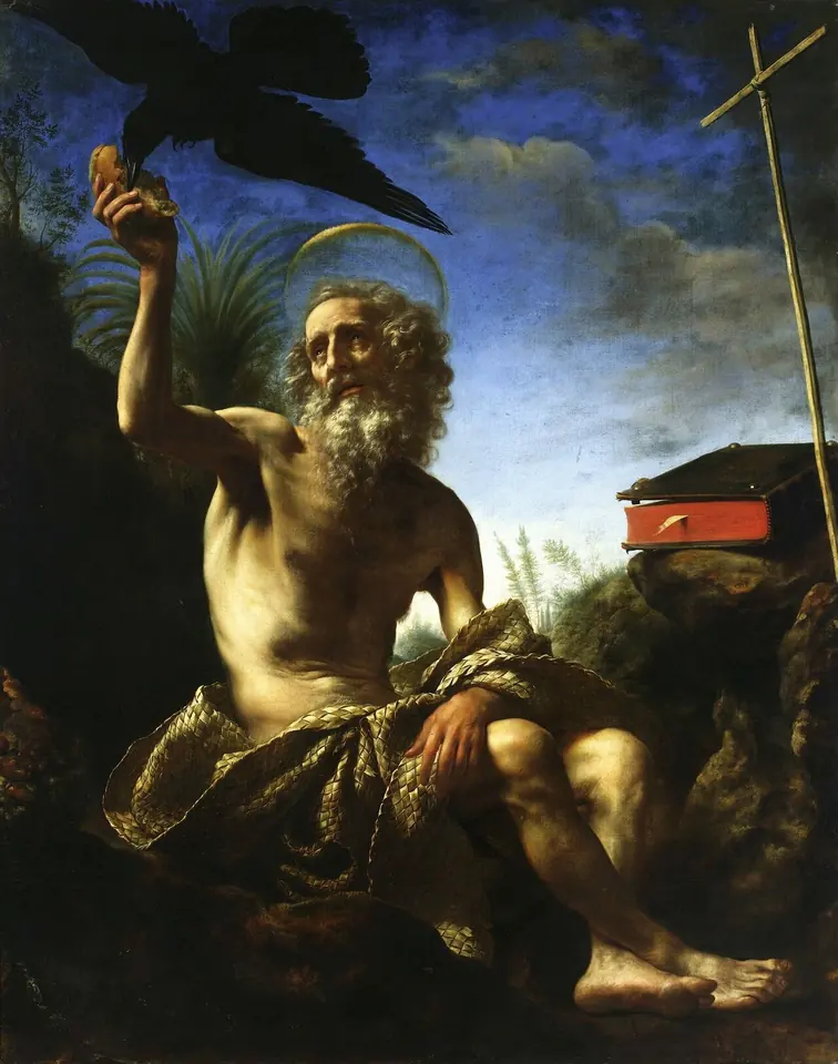 An old bearded hermit with a halo, wrapped in a cloth, seated by a rock under a blue sky and reaching up to take a small loaf from a black raven, with a book and a reed cross nearby