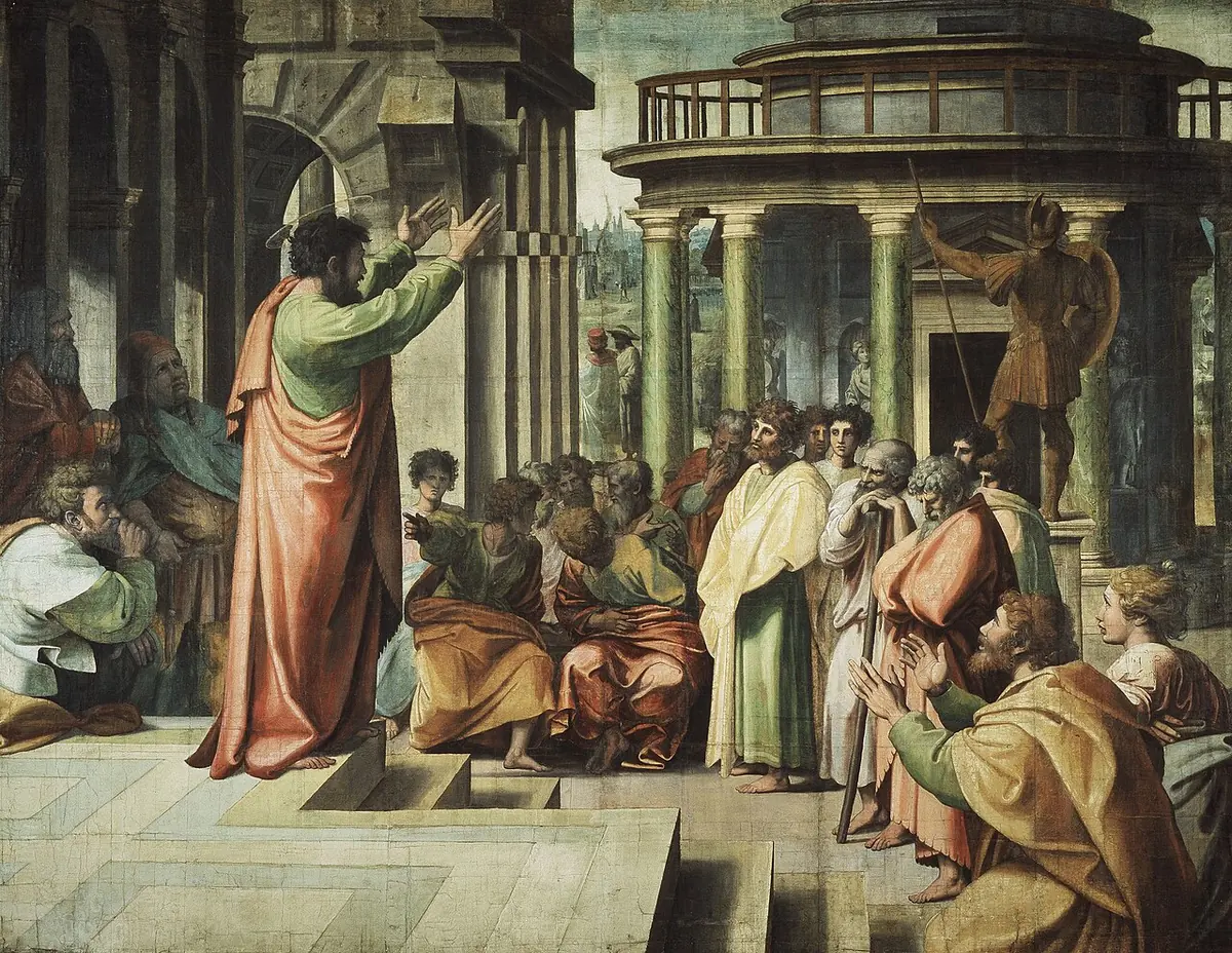 Raphael's cartoon of Paul in a red cloak standing on steps with both arms raised, preaching to a crowd of Athenian philosophers before a round temple with a statue of Mars