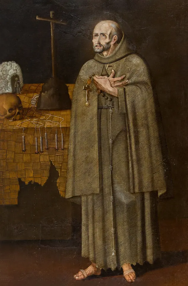 Painting of a gaunt standing friar in a brown habit and knotted cord, hands crossed on his chest holding a rosary, beside a table with a cross, a skull, a honeycomb and instruments of penance