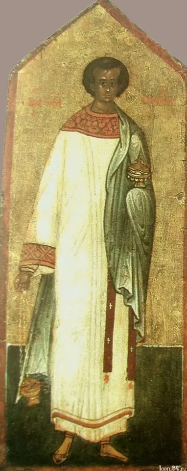 Tall icon on a gold ground of a young saint in a long white deacon's tunic with a green cloak, holding a small gold incense box in one hand and a censer in the other