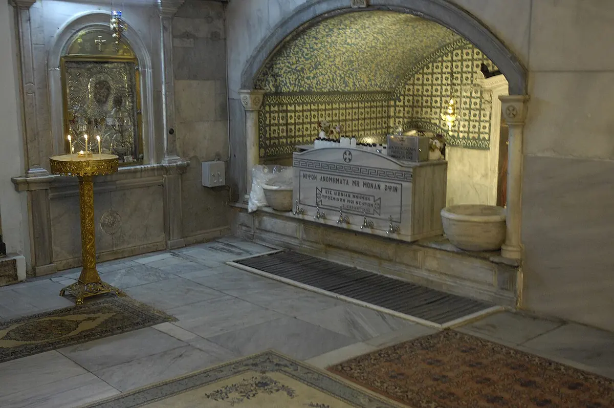 Interior of the small church of St. Mary of Blachernae in Istanbul with an icon, oil lamps and a white marble fountain in a tiled alcove