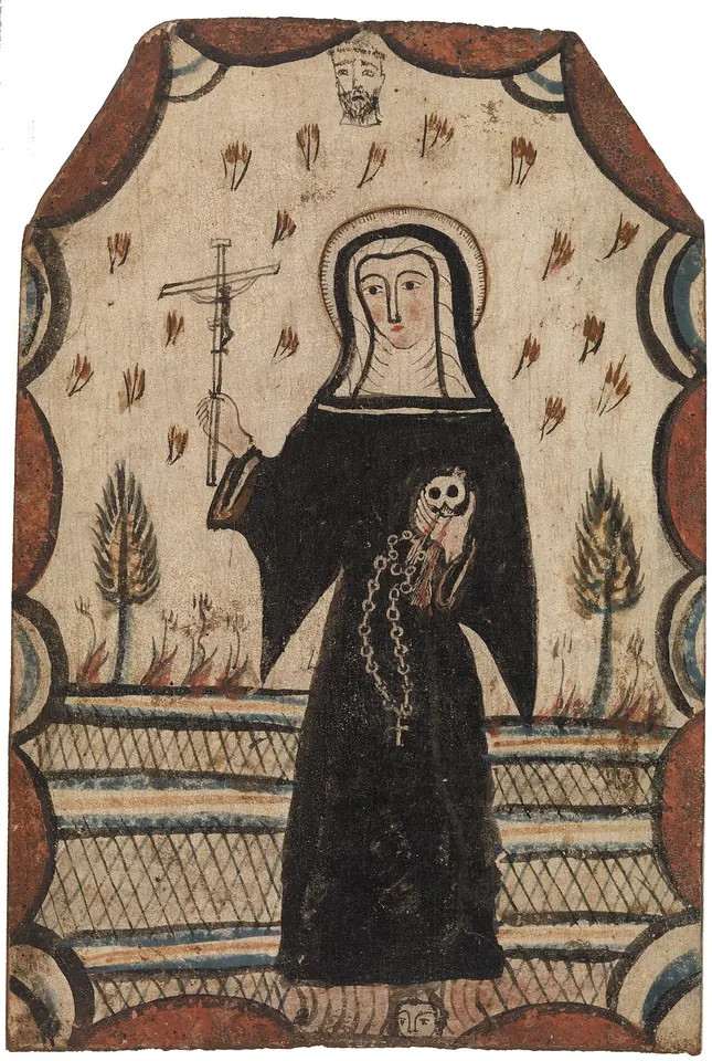 New Mexican painted wooden panel of St. Rita in a black habit holding a crucifix and a skull, with stylized trees and red flower sprigs around her
