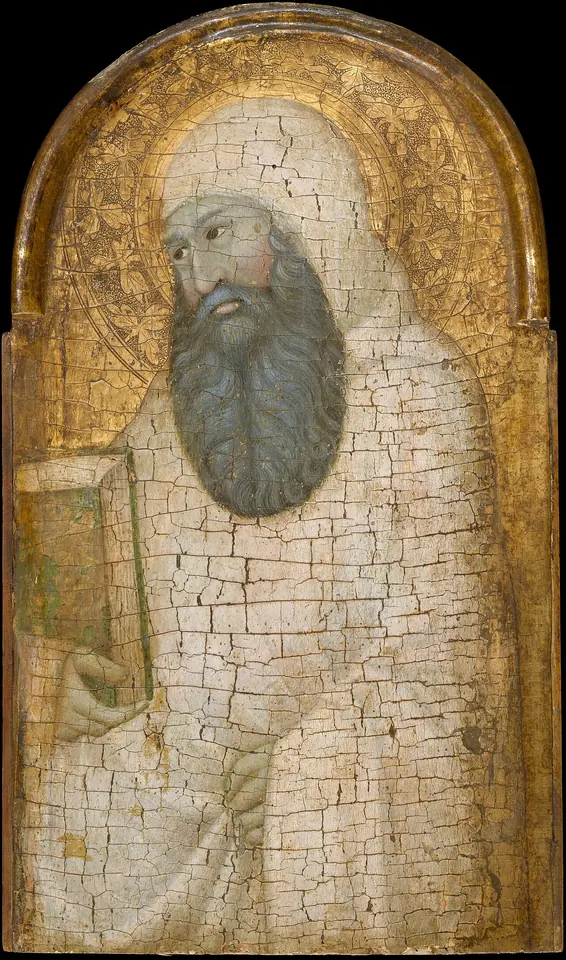 Cracked fourteenth-century gold-ground panel of an old monk with a long gray beard, his white hood drawn over his head, holding a book