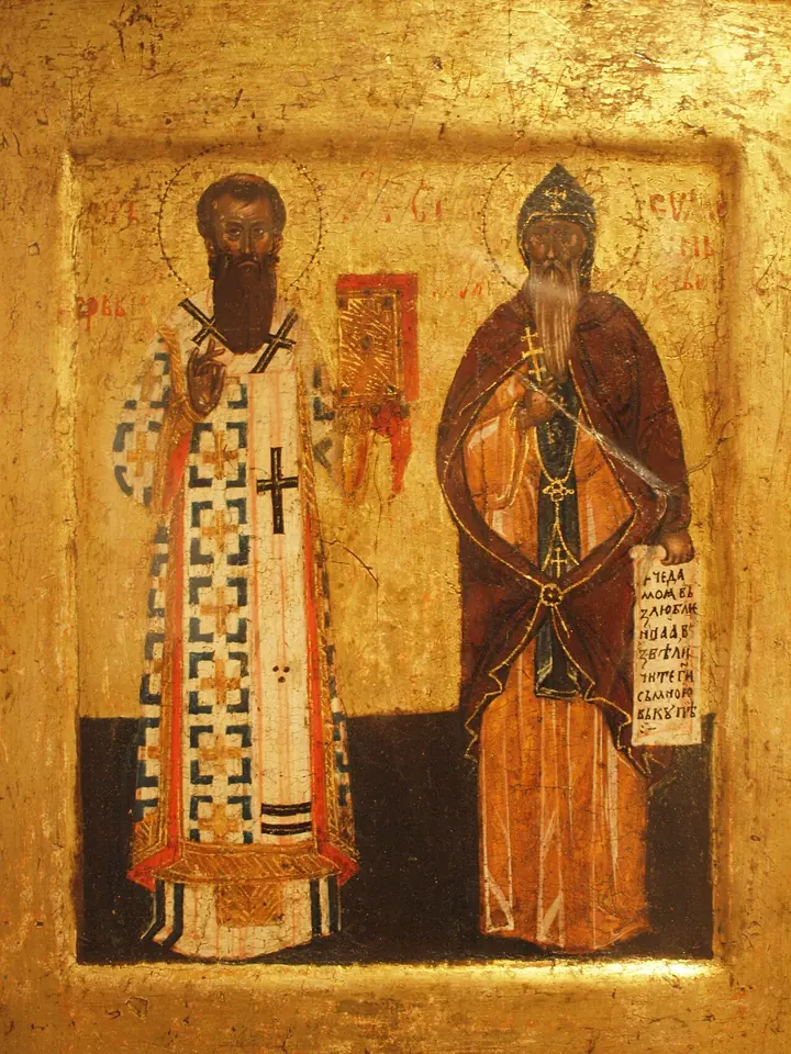 Gold-ground icon of St. Sava in white archbishop's vestments with crosses standing beside his father St. Simeon in a brown monk's habit holding a scroll