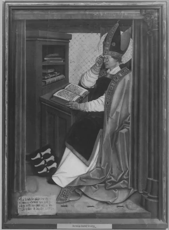 Panel painting of a bishop in a white miter seated at a reading desk in a small study, reading from an open book