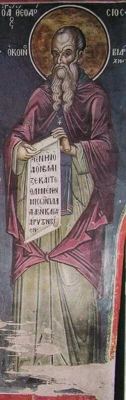 Tall, narrow fresco of an old monk with a long beard in a red-brown mantle holding an open scroll covered in Greek writing