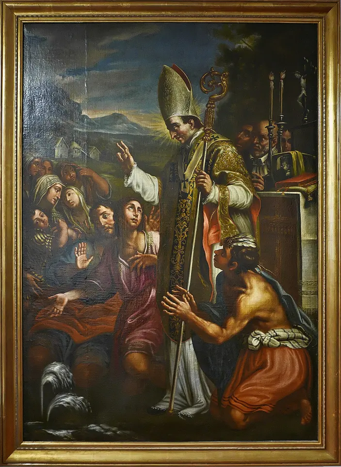 Painting of Turibius in a miter and gold cope blessing a kneeling native man while women and children crowd around him