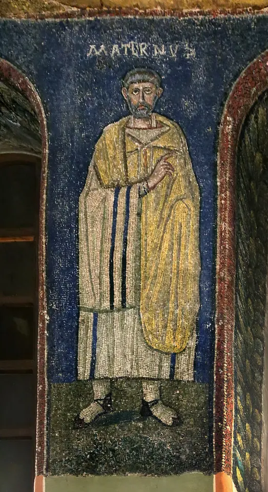 A standing mosaic figure of the bishop St. Maternus in a golden-yellow mantle against a deep blue background, with his name above him