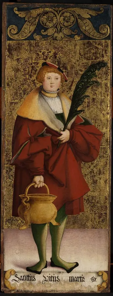 Standing figure of St. Vitus as a young nobleman in a red cloak and fur-trimmed hat, holding a palm branch and a small metal cauldron by its handle