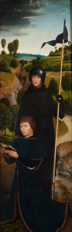 Tall narrow panel of a hermit saint in a dark habit and a steel helmet holding a banner on a staff, standing behind a kneeling young man in black with a prayer book, before a green landscape