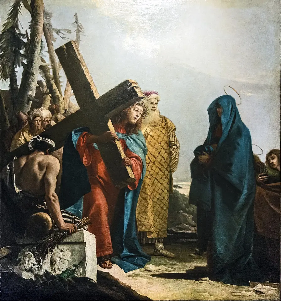 Jesús, con túnica roja, se inclina bajo una pesada cruz de madera y se vuelve hacia su madre, que está aparte con un manto azul oscuro y la cabeza inclinada