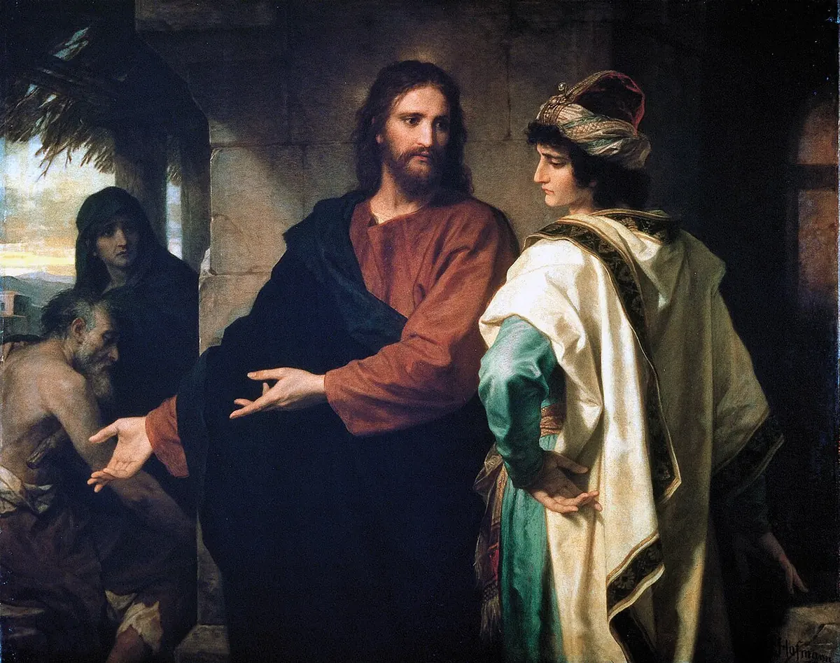 Christ in a red robe and dark mantle gestures toward a poor old man and woman in the shadows, while a richly dressed young man in a striped turban turns away with a troubled face