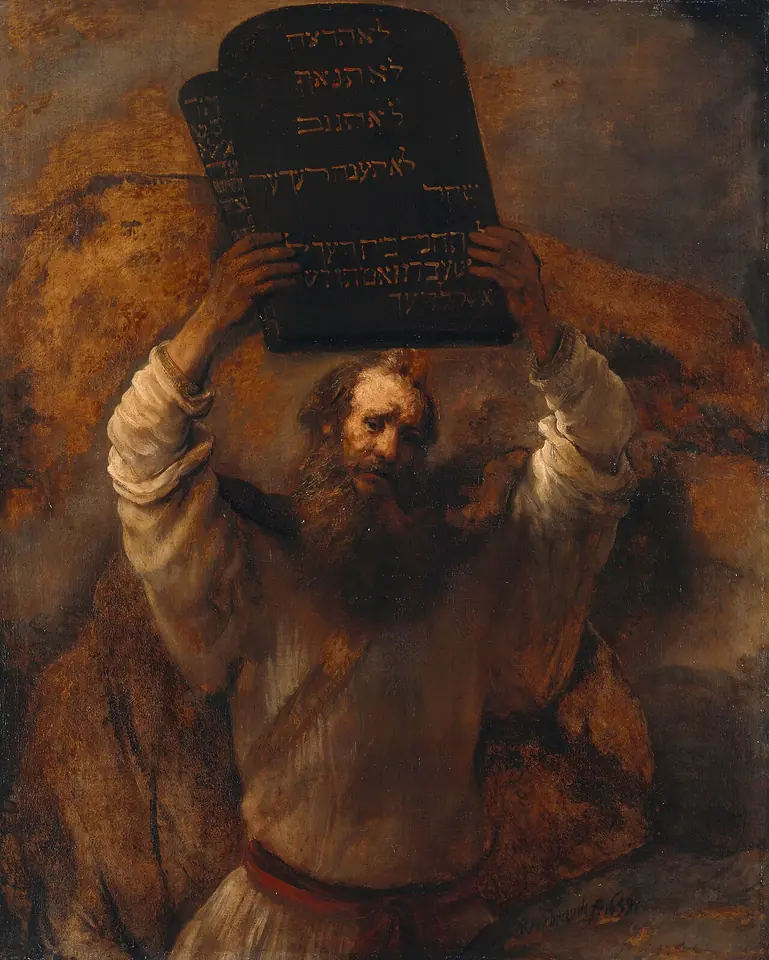 Moses, an old bearded man in a brown robe, holds the two stone tablets inscribed in Hebrew high above his head against a dark mountain background