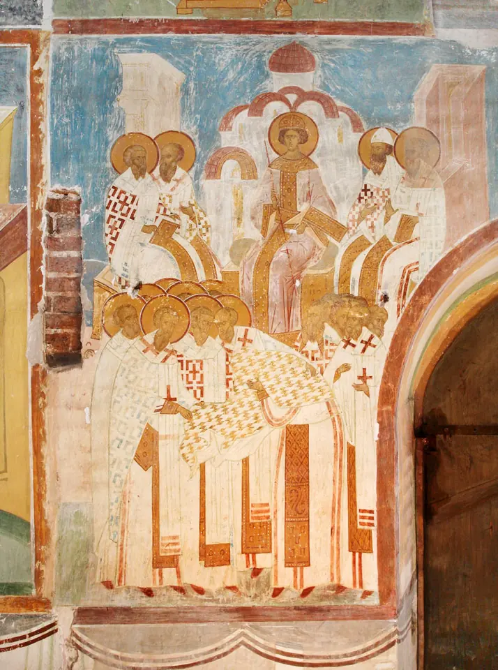 Russian fresco of haloed bishops in white vestments gathered in rows beneath church buildings, around a central enthroned figure, depicting the Council of Ephesus