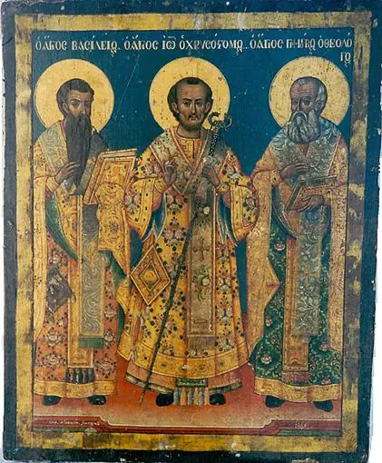 Greek icon of three bishops in gold and green vestments on a dark blue ground, with Greek inscriptions naming Basil, John Chrysostom and Gregory the Theologian