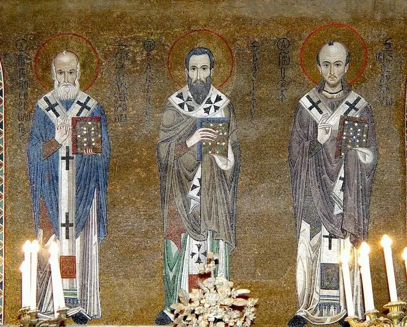 Gold-ground mosaic of three standing bishops in vestments with crosses, the left one white-bearded in blue, the middle one dark-bearded, the right one balding with a short beard