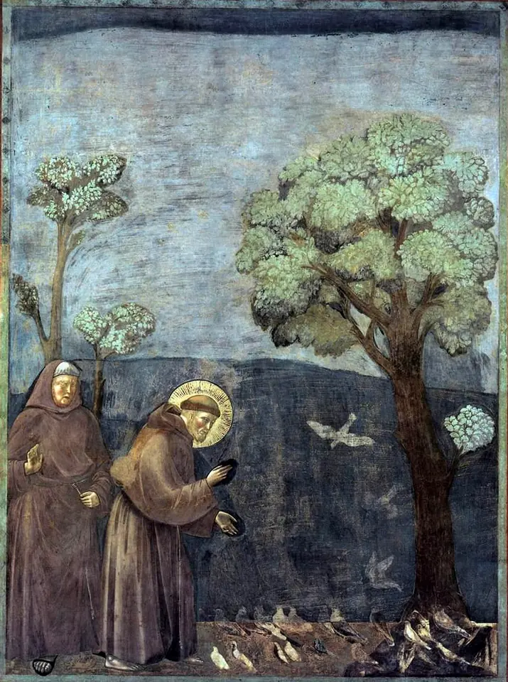 Fresco of St. Francis in a brown habit bending toward a flock of birds gathered at his feet beneath a tree, while another friar watches