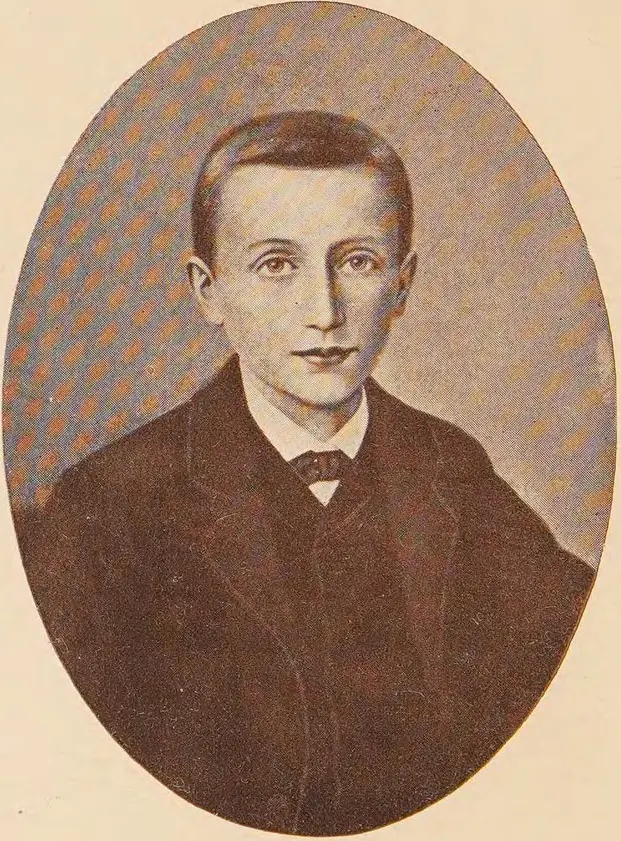 Oval tinted portrait of a thin teenage boy with neatly combed dark hair, a dark jacket, white collar and small bow tie